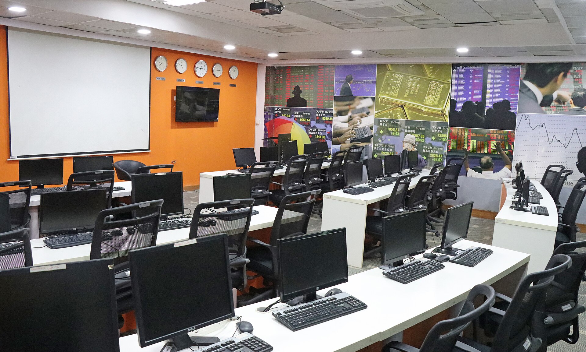 A university trading room with rows of desks and monitors